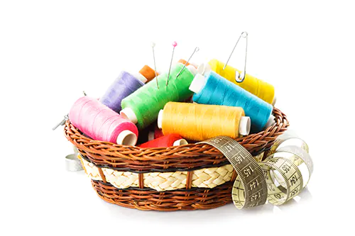 Colorful quilting thread inside of a basket.